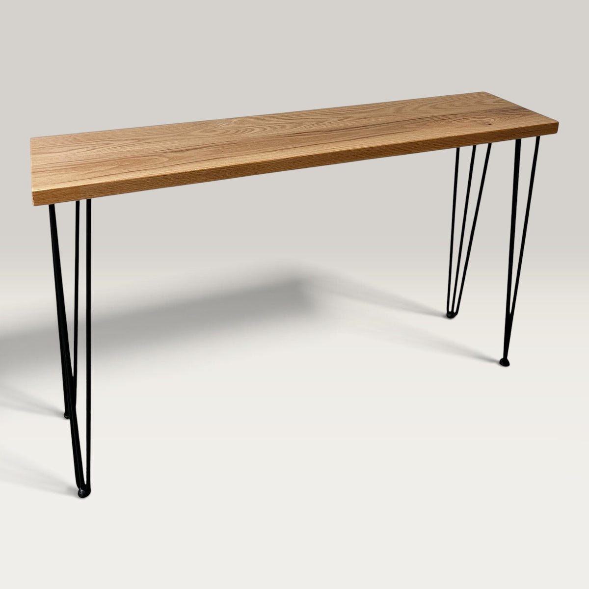 American Oak Modern Hallway Table — angled view showing steel hairpin legs and natural American Oak timber top