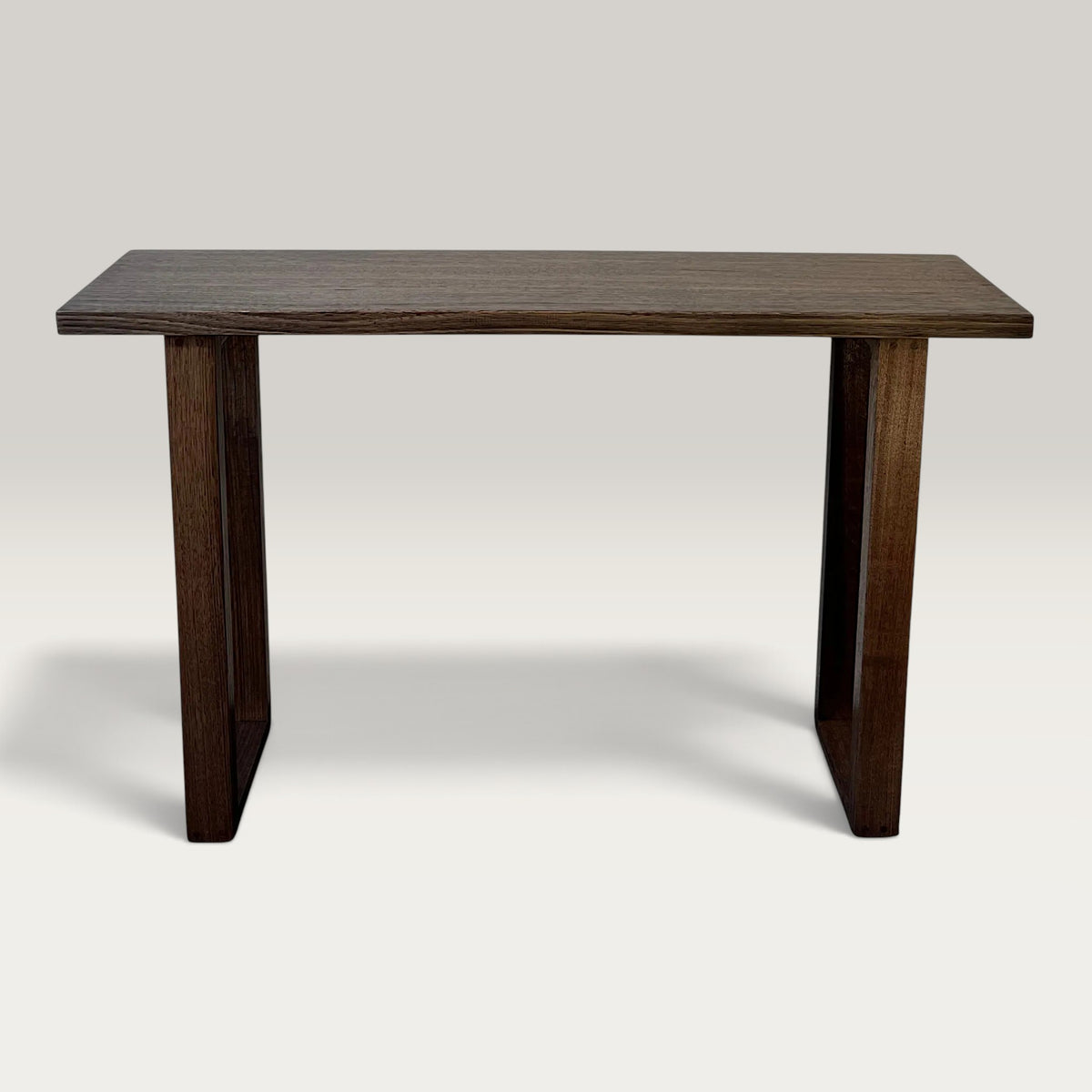 Dark Oak Classic Hallway Table — a dark hardwood console table ski legs, front on image on a light background